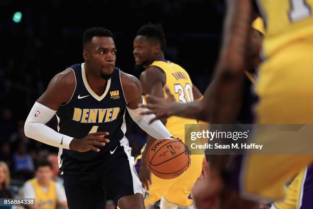 Paul Millsap of the Denver Nuggets dribbles upcourt during the first half of a preseason game against the Los Angeles Lakers at Staples Center on...