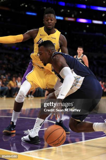 Julius Randle of the Los Angeles Lakers defends against Paul Millsap of the Denver Nuggets during the first half of a preseason game at Staples...