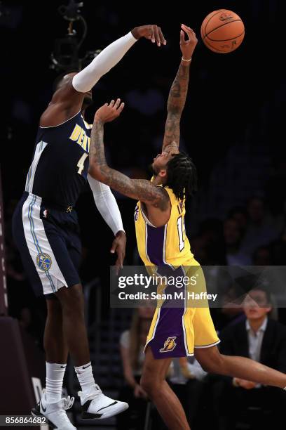 Paul Millsap of the Denver Nuggets blocks a shot by Brandon Ingram of the Los Angeles Lakers during the first half of a preseason game at Staples...