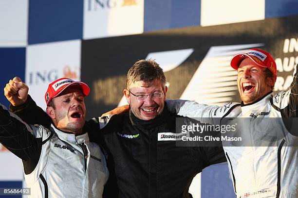 Race winner Jenson Button of Great Britain and Brawn GP celebrates with Team Principal Ross Brawn and second placed Rubens Barrichello of Brazil and...