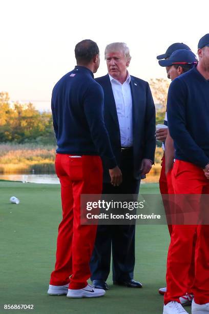The President of the United States Donald Trump talks with Tiger Woods at the Presidents Cup on October 1 at Liberty National Golf Clubin Jersey City...
