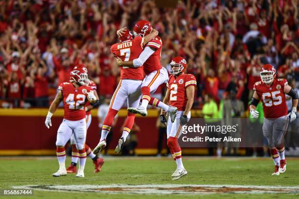Kicker Harrison Butker of the Kansas City Chiefs and teammate James Winchester celebrate mid air after kicking the go ahead field goal with eight...