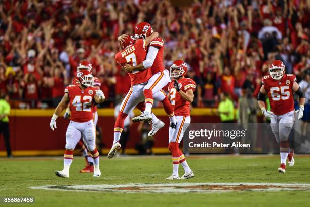 Kicker Harrison Butker of the Kansas City Chiefs and teammate James Winchester celebrate mid air after kicking the go ahead field goal with eight...