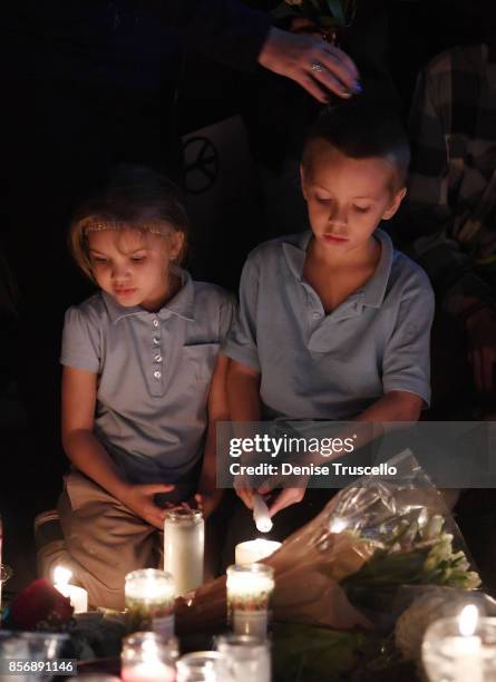 Aryanna Williams and Mickey Deustch of Las Vegas, Nevada attend a vigil on the Las Vegas strip for the victims of the Route 91 Harvest country music...