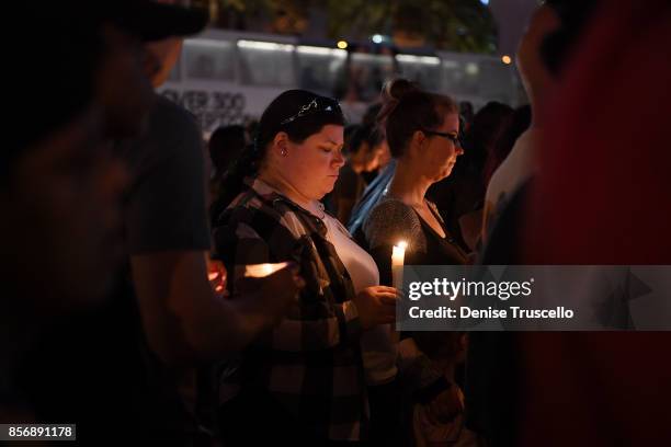 Hundreds of people gather for a vigil on the Las Vegas strip, for the victims of the Route 91 Harvest country music festival shootings on October 2,...