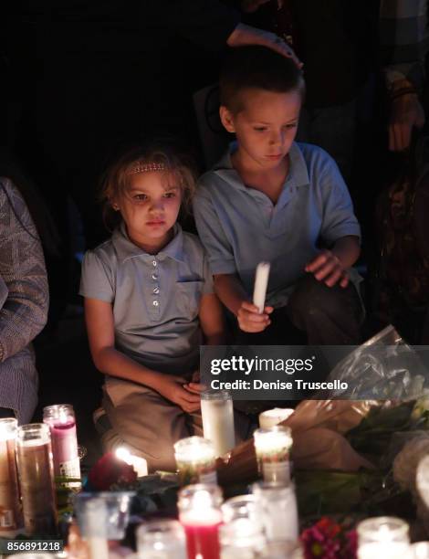 Aryanna Williams and Mickey Deustch of Las Vegas, Nevada attend a vigil on the Las Vegas strip for the victims of the Route 91 Harvest country music...