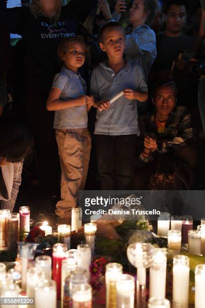 Aryanna Williams and Mickey Deustch of Las Vegas, Nevada attend a vigil on the Las Vegas strip for the victims of the Route 91 Harvest country music...