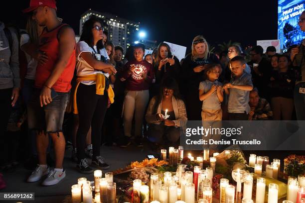 Hundreds of people gather for a vigil on the Las Vegas strip, for the victims of the Route 91 Harvest country music festival shootings on October 2,...