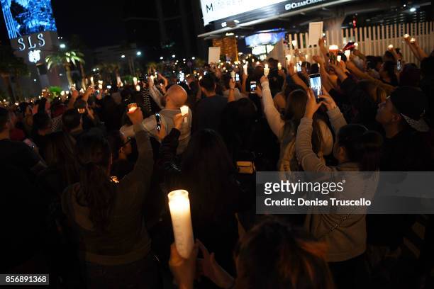 Hundreds of people gather for a vigil on the Las Vegas strip, for the victims of the Route 91 Harvest country music festival shootings on October 2,...