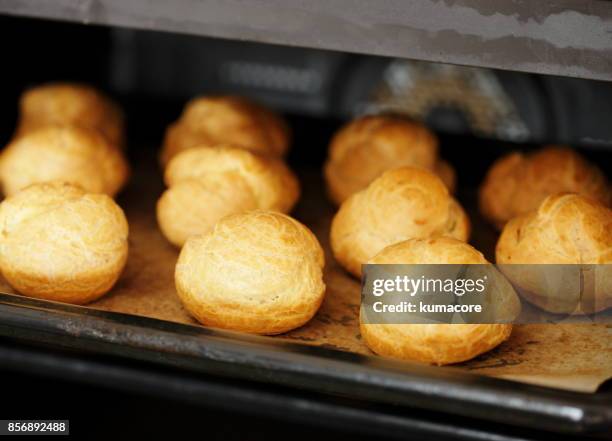 cream puffs in electric oven - cream cake stock pictures, royalty-free photos & images