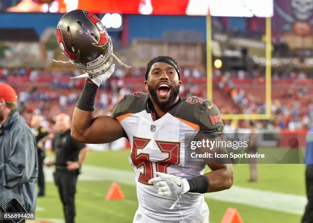 Happy Tampa Bay Buccaneers linebacker Cameron Lynch runs after the field after an NFL football game between the New York Giants and the Tampa Bay...
