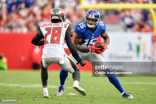 New York Giants wide receiver Brandon Marshall looks to avoid Tampa Bay Buccaneers cornerback Vernon Hargreaves III after a reception during an NFL...