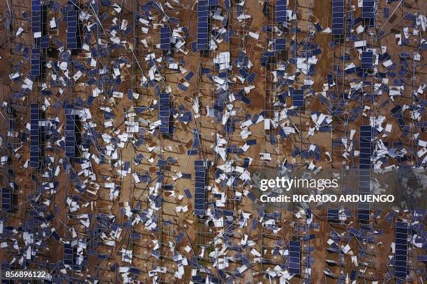 Solar panel debris is seen scattered in a solar panel field in the aftermath of Hurricane Maria in Humacao, Puerto Rico on October 2, 2017. President...