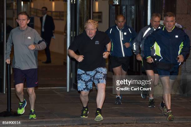 Foreign Secretary Boris Johnson and editor of The Sun newspaper, Tony Gallagher , go for a morning jog on day three of the annual Conservative Party...