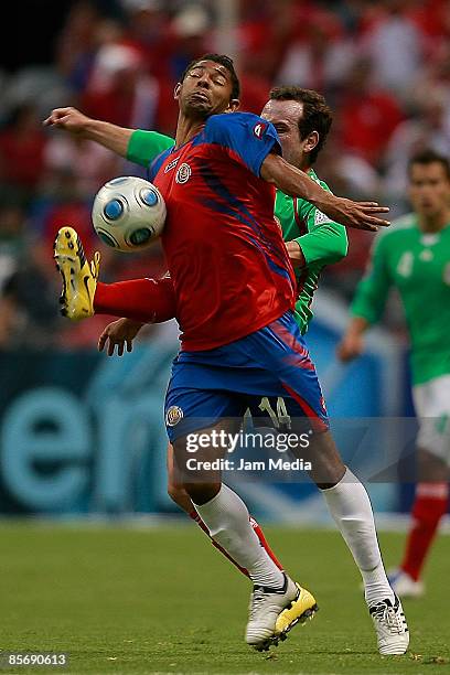 Gerardo Torrado of Mexico and Michael Barrantes of Costa Rica fight for the ball during their FIFA 2010 World Cup Qualifying match at the Azteca...