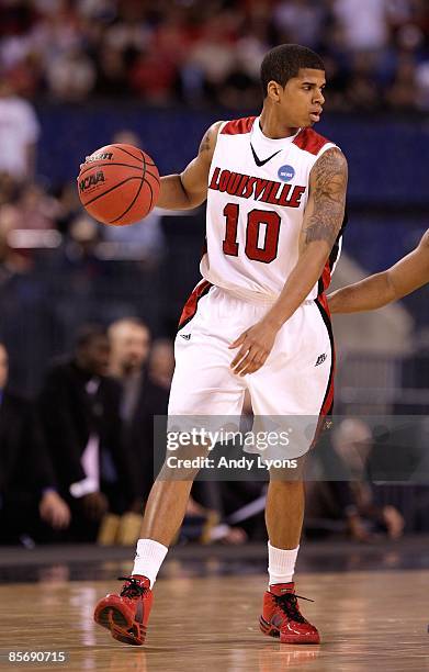 Edgar Sosa of the Louisville Cardinals looks to pass the ball against the Arizona Wildcats during the third round of the NCAA Division I Men's...