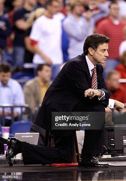 Head coach Rick Pitino of the Louisville Cardinals kneels on the court as he looks on against the Arizona Wildcats during the third round of the NCAA...