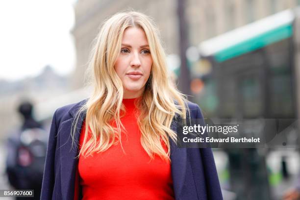 Ellie Goulding wears a blue coat, a red top, a skirt, outside Stella Mccartney, during Paris Fashion Week Womenswear Spring/Summer 2018, on October...