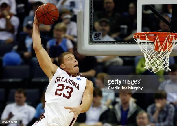 Blake Griffin of the Oklahoma Sooners dunks the ball as he hits his head on the side on the backboard in the second half against the Syracuse Orange...