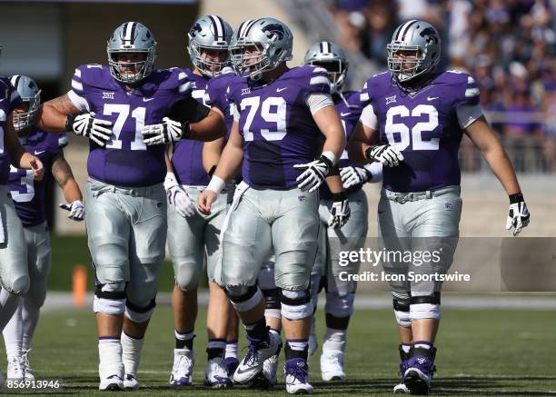 Kansas State Wildcats offensive lineman Dalton Risner , Adam Holtorf and Tyler Mitchell in the first half of a Big 12 game between the Baylor Bears...