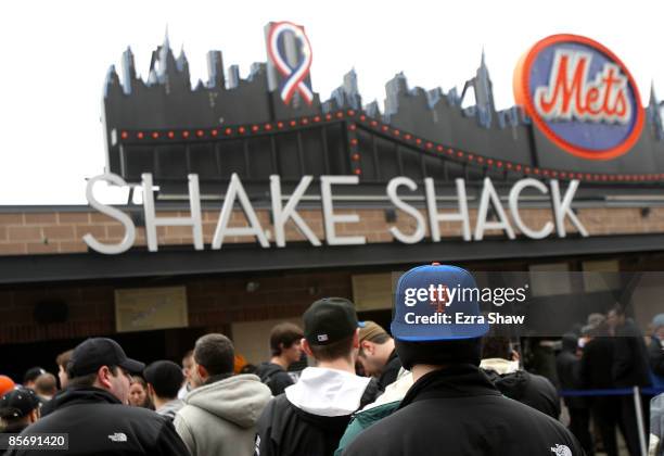 Spectators line up to get food at the Shake Shack during the Georgetown and St. Johns game at Citi Field on March 29, 2009 in the Flushing...