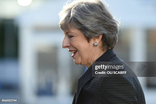 Britain's Prime Minister Theresa May gestures as she arrives at the Manchester Central Convention Centre in Manchester on October 3 the third day of...