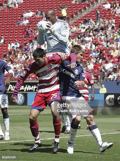 Zach Thornton goal keeper for the Chivas USA stops a conner kick as Steve Purdy of the FC Dallas and Jesse Marsch of the Chivas defend the play on...