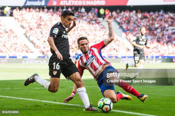 Saul Niguez Esclapez of Atletico de Madrid battles for the ball with Jesus Navas Gonzalez of Sevilla FC during the La Liga 2017-18 match between...