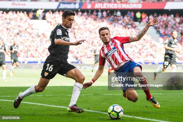 Saul Niguez Esclapez of Atletico de Madrid battles for the ball with Jesus Navas Gonzalez of Sevilla FC during the La Liga 2017-18 match between...