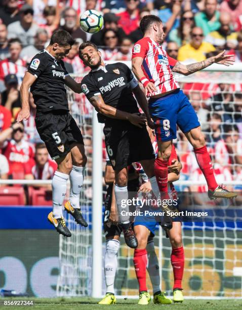 Clement Nicolas Laurent Lenglet and Daniel Filipe Martins Carrico of Sevilla FC fights for the ball with Saul Niguez Esclapez of Atletico de Madrid...