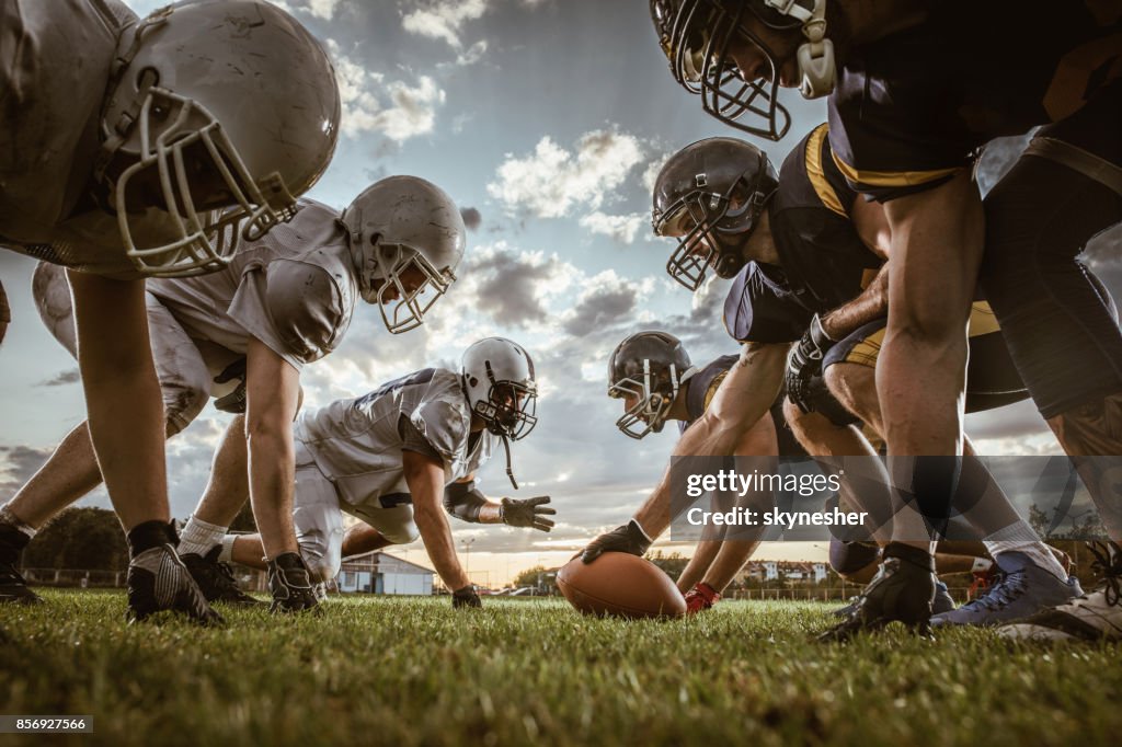 Below view of American football players on a beginning of the match.