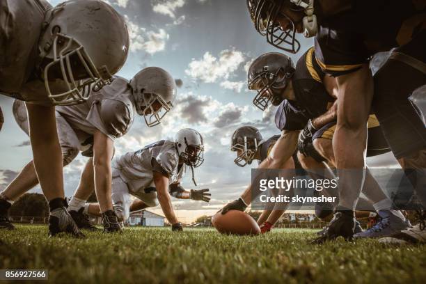below view of american football players on a beginning of the match. - american football stock pictures, royalty-free photos & images