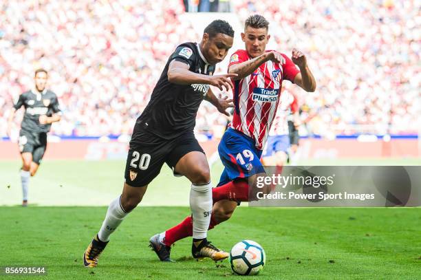 Luis Muriel of Sevilla FC fights for the ball with Lucas Hernandez of Atletico de Madrid during the La Liga 2017-18 match between Atletico de Madrid...