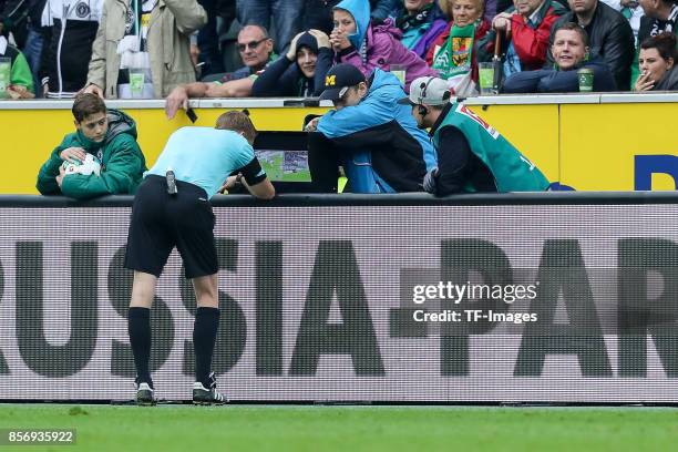 Referee Christian Dingert uses a video assistant to decide about penalty sichtet den Videobeweis during the Bundesliga match between Borussia...