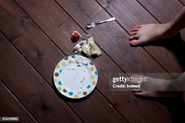 girl dropping cake on floor - kuchenboden stock-fotos und bilder