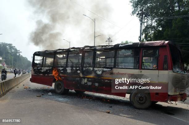 An Indian bus burns on a street after being set on fire by Bahujan Samaj Party supporters in Allahabad on October 3 after a BSP leader was shot dead....
