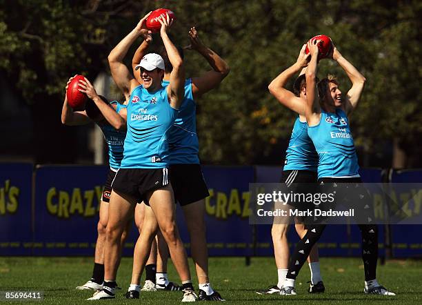 Nathan Brown and Dale Thomas of the Magpies pass the ball in a warm up drill during a Collingwood Magpies AFL training session at Gosch's Paddock on...