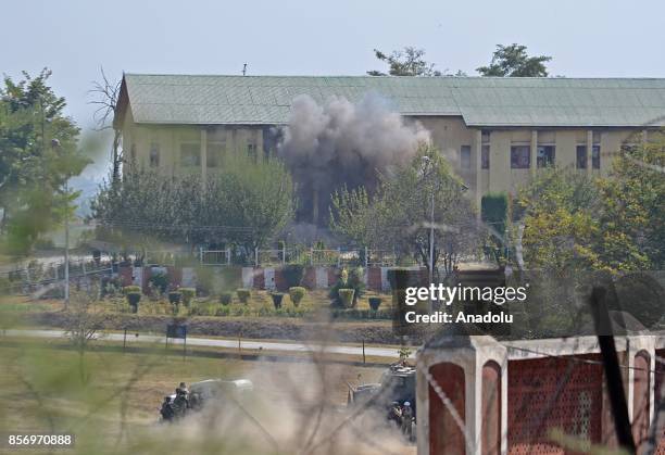 Smoke rises from the Indian military building after it was blasted by Indian army where last suspected militant was believed to be holed up in...