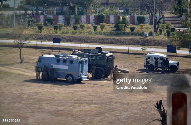 Indian army men take cover near the building where last suspected militant was believed to be holed up in Humhama on the outskirts of Srinagar the...