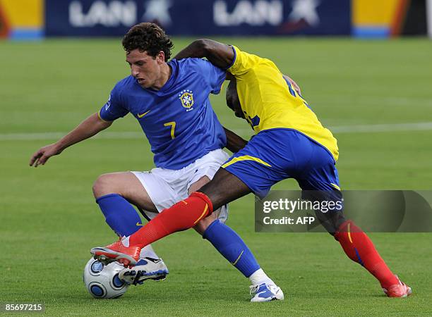 Brazilian Elano vies for the ball with Ecuador 's Walter Ayovi during a FIFA World Cup South Africa-2010 qualifier football match at the Atahualpa...