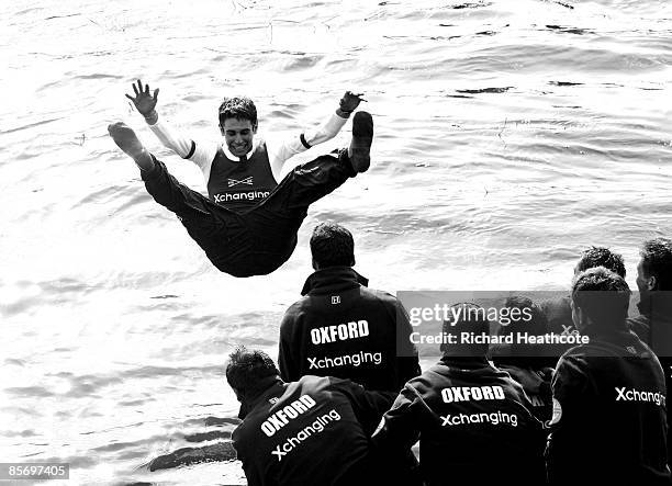 Cox Colin Groshong is thrown into the River Thames in celebration after Oxford are victorious during the 155th Oxford & Cambridge University Boat...