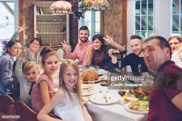 holiday season - big family dinner stock pictures, royalty-free photos & images