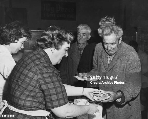 Thanksgiving dinner is served to the homeless by the Volunteers of America, at the Bowery Tabernacle on East Houston Street, circa 1935. More than...