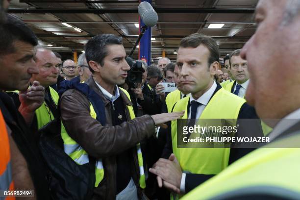 La France Insoumise leftist party's MP Francois Ruffin gestures as he speaks to French President Emmanuel Macron during a visit to the Whirlpool...
