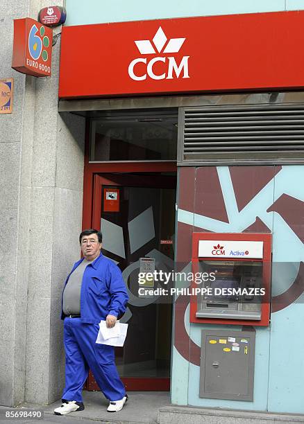 Man leaves a Caja de Ahorros Castilla La Mancha savings bank branch in Madrid, on March 30, 2009. Spain's central bank took over a struggling savings...