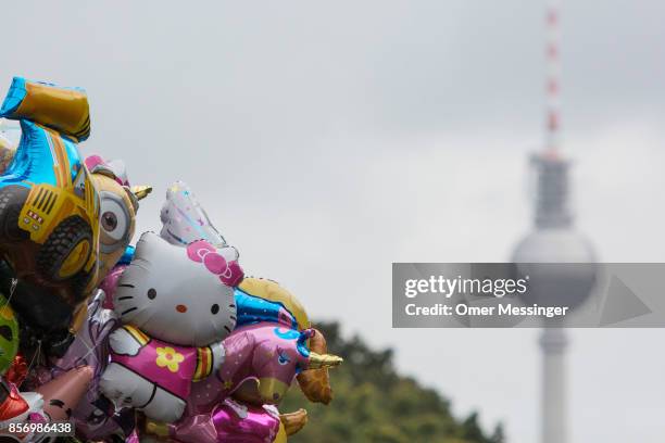 Balloons with ttthe image of cartoon characters are seen at an amusement area set up along 17th of June Street in Tiergarten Park near the...