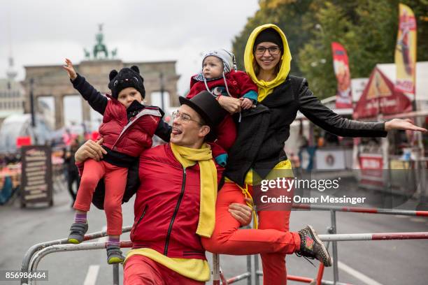 Acrobats Berlinjohn And Berlintina dressed in ttthe colors of the German national flag are seen holding their children Jet and his sister (Junia at...