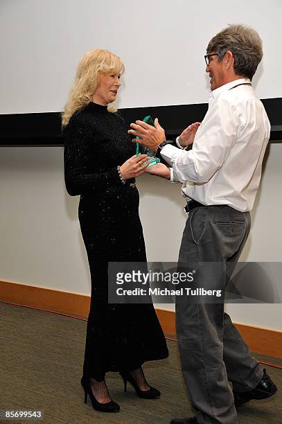 Actress Loretta Swit accepts the award for Achievement in Television from actor Eric Roberts at the Closing Night Gala for the 1st Annual Burbank...