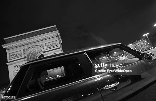 Woman smoking a cigarette in front of the famous france landmark Arc de Triomphe de L´Etoile in Paris, France on February 25,2009. It was built in...