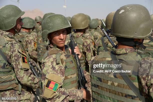 Newly-graduated Afghan National Army cadets march during a graduation ceremony at the ANA training centre in Herat province on October 3, 2017....